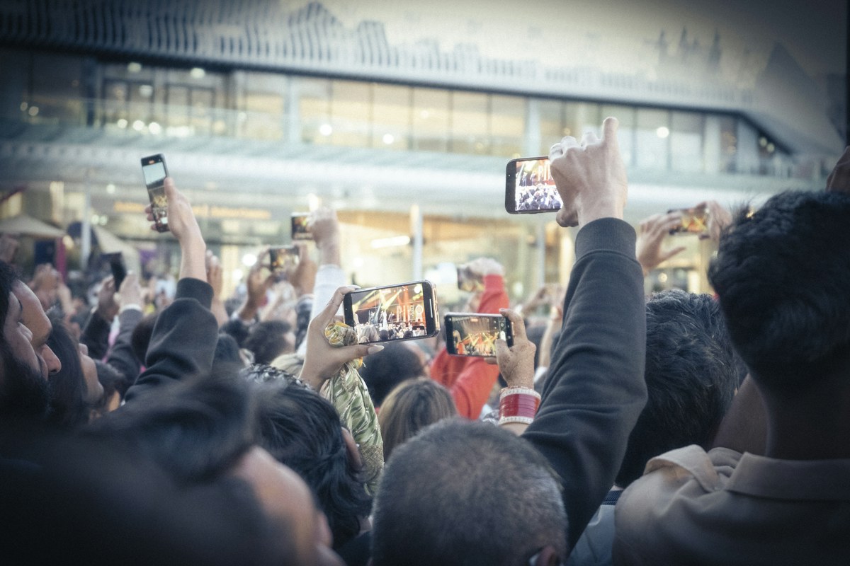 People capturing a live moment on their phones